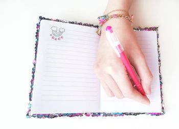 Directly above shot of woman hand holding paper