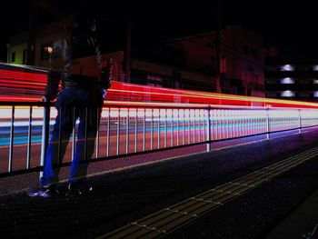 Light trails on railroad station platform at night