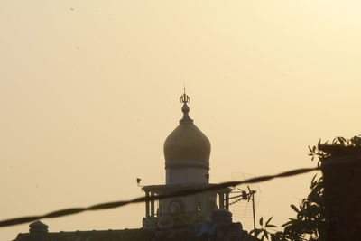 Low angle view of building against sky during sunset