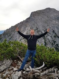 Man standing on rock against mountain