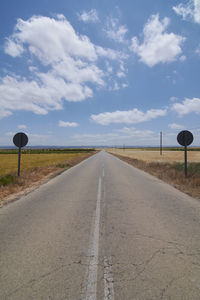 Road between wheat fields before harvest, colors of nature