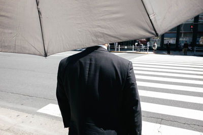 Rear view of people walking in city