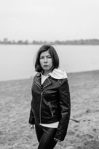 Portrait of woman standing against sea