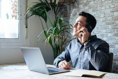 Young woman using laptop at office