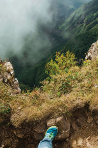 Low section of person standing on mountain