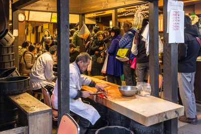 Group of people at market stall