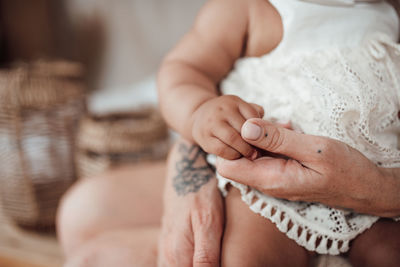 Close-up of hands holding baby feet