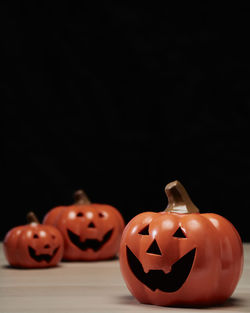 Close-up of pumpkin on table against black background