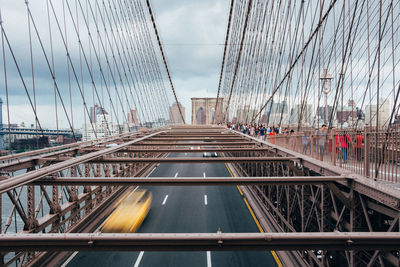 Bridge in city against sky