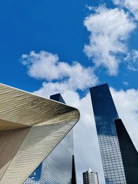 Low angle view of buildings against cloudy sky