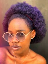 Close-up portrait of young woman wearing sunglasses