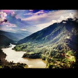 Scenic view of mountains against cloudy sky