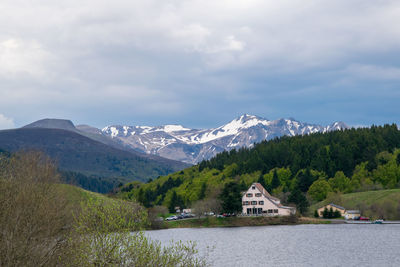 Scenic view of lake by mountains against sky