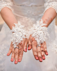 Midsection of bride wearing gloves