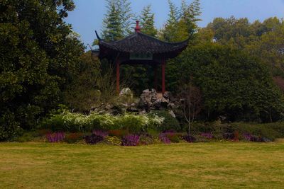 Gazebo in temple by trees against sky