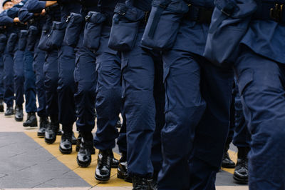 Low section of army soldiers on road