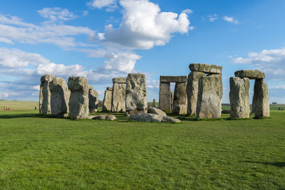 Panoramic view of old ruins on field against sky