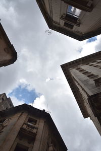 Low angle view of buildings in city against sky