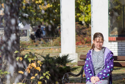 Portrait of smiling child standing against plants