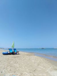 Scenic view of beach against clear blue sky