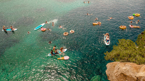 High angle view of people swimming in sea