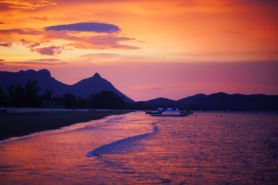 Scenic view of sea against romantic sky at sunset