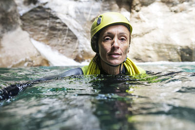 Portrait of mature female scuba diver in river