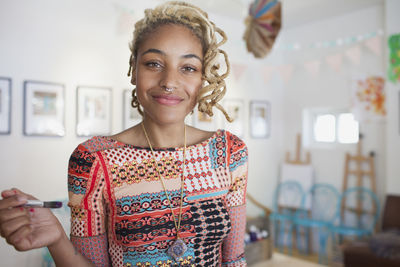 A young woman with a paintbrush