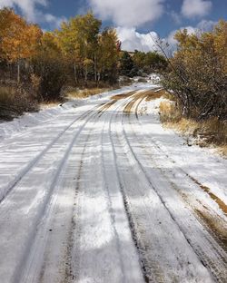 Surface level of road against sky during winter