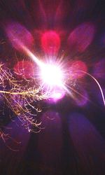 Low angle view of illuminated lights at night