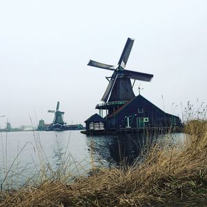 Cranes in water against sky