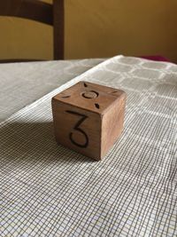 High angle view of wooden block with number on table