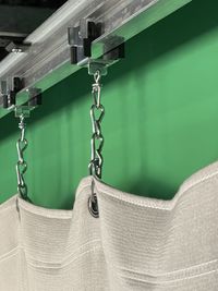 Close-up of clothes hanging on metal grate