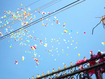 Low angle view of flags against sky