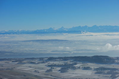 Scenic view of landscape against blue sky