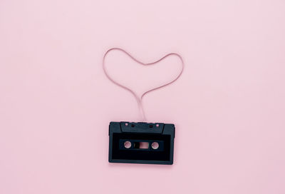 Close-up of heart shape on pink wall