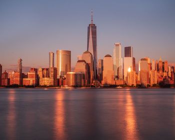 Illuminated buildings in city at waterfront