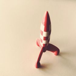 Close-up of toy on table against white background