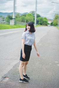 Woman walking on road in city