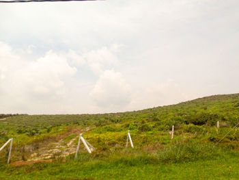 Scenic view of landscape against cloudy sky