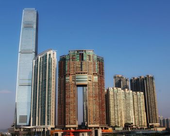 Low angle view of modern buildings against clear blue sky