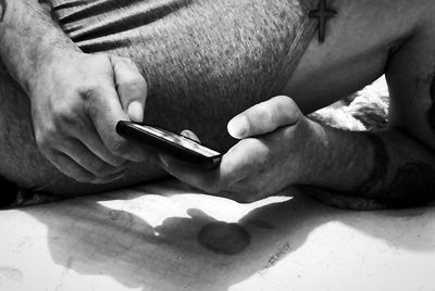 Close-up midsection of man using phone