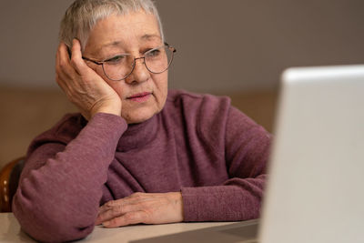 Senior woman using laptop at home