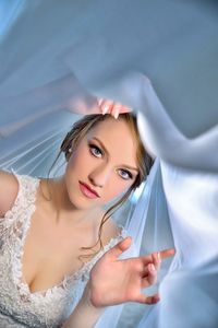 Portrait of beautiful woman covered in curtain