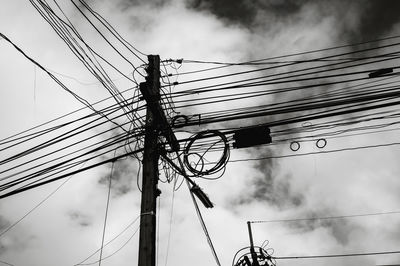 High voltage power pole with wires tangled, wire and cable clutter.