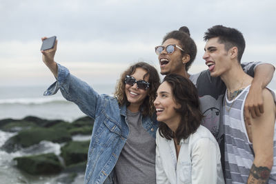 Friends posing for a selfie on the beach