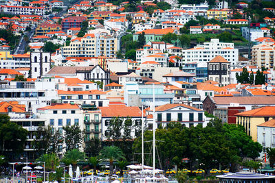 Aerial view of town by buildings in city