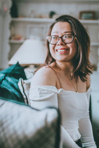 Portrait of smiling young woman at home