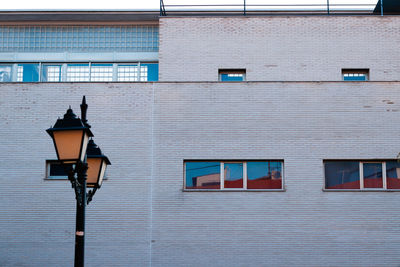 Low angle view of street light against building