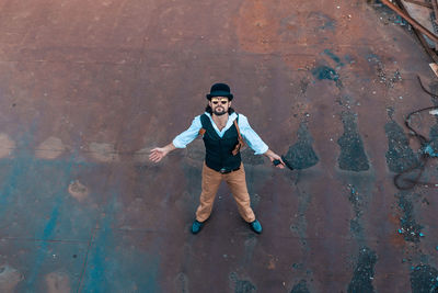 High angle portrait of smiling boy standing outdoors